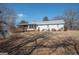 Rear view of the home showcasing a wooden deck and neutral siding at 382 Lamb Rd, Moreland, GA 30259