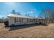 Exterior view of home with metal roof and shutters and a covered parking area at 382 Lamb Rd, Moreland, GA 30259