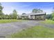 Exterior view of home featuring covered carport and a long gravel driveway at 382 Lamb Rd, Moreland, GA 30259