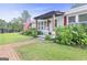 Inviting front porch with rocking chair, lush landscaping, and charming curb appeal at 382 Lamb Rd, Moreland, GA 30259