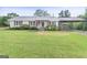 Charming one-story home featuring a metal roof, a cozy front porch and covered carport at 382 Lamb Rd, Moreland, GA 30259