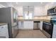 Contemporary kitchen with stainless steel appliances, granite countertops, and updated cabinetry at 382 Lamb Rd, Moreland, GA 30259