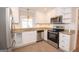 Modern kitchen featuring stainless steel appliances, granite countertops, and white cabinetry at 382 Lamb Rd, Moreland, GA 30259