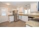 Well-lit kitchen with stainless steel appliances, granite countertops, and ample cabinet space at 382 Lamb Rd, Moreland, GA 30259