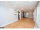 Spacious living room with hardwood floors, modern lighting, and access to additional rooms at 382 Lamb Rd, Moreland, GA 30259