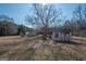 View of yard with shed and bare trees under a blue sky at 382 Lamb Rd, Moreland, GA 30259