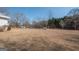 Expansive backyard featuring mature trees and a utility building at 382 Lamb Rd, Moreland, GA 30259