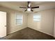 Neutral bedroom featuring ceiling fan, carpeted floor and natural light from two windows at 2343 Deer Pass Way, Decatur, GA 30035