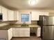 Well-lit kitchen featuring stainless steel appliances and ample white cabinetry with granite countertops at 2343 Deer Pass Way, Decatur, GA 30035