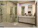 Modern bathroom featuring a glass shower, double vanity, and contemporary fixtures with neutral tones and clean lines at 330 Campground Rd, Mcdonough, GA 30253