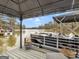 Covered boat dock featuring a modern boat with seating and tranquil lake views at 2766 Jodeco Dr, Jonesboro, GA 30236