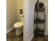 Small bathroom featuring a toilet with a decorative shelf at 9135 Gladwyne Xing, Villa Rica, GA 30180