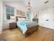 Well-lit bedroom features wood accents and flooring, and a decorative chandelier adding charm to the space at 130 Glasgow Ln, Fayetteville, GA 30214
