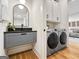 Practical laundry area with modern machines and contemporary gray shelving at 130 Glasgow Ln, Fayetteville, GA 30214