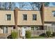 Charming townhome featuring unique shingle siding and well-maintained front yard landscaping at 6430 Woodstone Way, Morrow, GA 30260