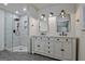 Updated bathroom with dual sinks, modern lighting and tiled shower at 185 Redwood Cir, Fayetteville, GA 30214