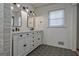 Elegant bathroom featuring double vanity, bronze fixtures, hexagonal tile flooring, and shiplap walls at 185 Redwood Cir, Fayetteville, GA 30214