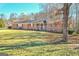 Charming brick home with a lush front yard, welcoming stone accents, and a cozy front porch at 185 Redwood Cir, Fayetteville, GA 30214