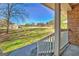 Spacious front yard view from the covered front porch with white railing at 185 Redwood Cir, Fayetteville, GA 30214