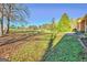 Expansive front yard view with trees, lush lawn, and a glimpse of nearby homes at 185 Redwood Cir, Fayetteville, GA 30214