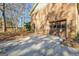 A brick two-car garage features a brown door with windows and a concrete driveway at 185 Redwood Cir, Fayetteville, GA 30214