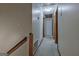 Neutral hallway featuring carpet, multiple doorways, and a stairwell at 185 Redwood Cir, Fayetteville, GA 30214