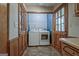 Well lit laundry room with washer, dryer and wood paneling at 185 Redwood Cir, Fayetteville, GA 30214