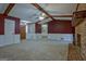 Living room showcasing brick fireplace, beamed ceiling, wainscotting, and neutral carpet at 185 Redwood Cir, Fayetteville, GA 30214