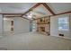 Spacious living room featuring a brick fireplace, ceiling fan, and neutral carpeting at 185 Redwood Cir, Fayetteville, GA 30214
