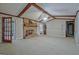 Bright living room with a brick fireplace, wood beam ceiling, and ample natural light at 185 Redwood Cir, Fayetteville, GA 30214