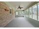 Bright sunroom enclosed with multiple windows, ceiling fan, and access to exterior at 185 Redwood Cir, Fayetteville, GA 30214
