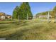 Large grassy yard partially enclosed with fencing that defines the property's boundary at 185 Redwood Cir, Fayetteville, GA 30214
