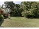 Exterior view of backyard featuring well-maintained lawn and wooded landscape at 2278 Honeysuckle Se Ln, Smyrna, GA 30080