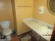 Compact bathroom with a toilet, sink, vanity, and tiled floor at 7755 Chase Woods Dr, Jonesboro, GA 30236