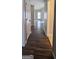 Inviting hallway featuring beautiful hardwood floors and neutral paint at 3223 Poplar Ridge Dr, Rex, GA 30273