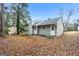 Back exterior view of home with a backyard covered with leaves and a grey exterior paint at 3417 Little Beth Ct, Decatur, GA 30034