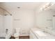 Bathroom featuring a shower-tub, white vanity with granite counters, and neutral walls at 3417 Little Beth Ct, Decatur, GA 30034