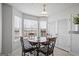 Bright breakfast nook with a round table, four chairs, and large windows at 825 Karie Dr, Mcdonough, GA 30253