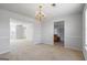 Open dining area adjacent to living spaces, illuminated by a stylish chandelier at 825 Karie Dr, Mcdonough, GA 30253