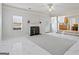 Spacious living room with white fireplace, tile floors, and access to the kitchen at 825 Karie Dr, Mcdonough, GA 30253