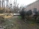 Backyard view of the home and the backyard lawn features a small deck at 5848 Navarre Ct, Stone Mountain, GA 30087