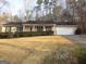 Charming ranch-style home with a manicured front yard, a covered porch, and an attached two-car garage at 5848 Navarre Ct, Stone Mountain, GA 30087