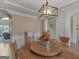 Elegant dining room with a round table, ornate chandelier, and views of the home's interior at 70 Caseys Way, Covington, GA 30014