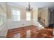 Sunlit dining room with hardwood floors, elegant chandelier, and wainscoting at 125 Westgreen Way, Tyrone, GA 30290