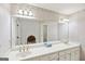 Bathroom with a large mirror and a long vanity with double sinks at 2999 Happy Hollow Se Dr, Conyers, GA 30094