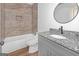 Bathroom features marble tile, a tub, and a granite vanity with an oval mirror at 6274 Booker Ln, Lithonia, GA 30058