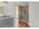 Bathroom features wood floors, marble shower, and a granite vanity with round mirror at 6274 Booker Ln, Lithonia, GA 30058