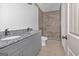 Granite double vanity in bathroom with stylish tiled shower and neutral color palette at 6274 Booker Ln, Lithonia, GA 30058