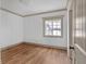 Bedroom with hardwood floors, large window, crown molding, and neutral color palette at 6274 Booker Ln, Lithonia, GA 30058