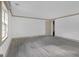 Bedroom with wood floors, neutral trim, and white walls with a single window at 6274 Booker Ln, Lithonia, GA 30058